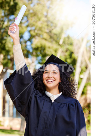 Up, up and away. Shot of a young woman cheering on graduation day. 107568130