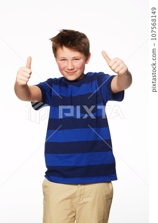Portrait, thumbs up and smile of kid in studio isolated on a white background. Boy, hand gesture and child with like emoji for agreement, success or thank you, yes sign and winner, ok and approval. Portrait, thumbs up and smile of kid in studio isolated on a white background. Boy, hand gesture and child with like emoji for agreement, success or thank you, yes sign and winner, ok and approval. 107568149