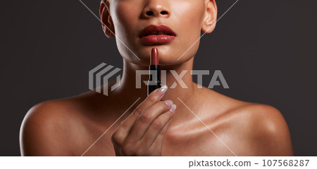 Beauty, makeup and lips of woman with lipstick in studio for cosmetics, skincare products and fashion. Salon aesthetic, cosmetology and girl model with red gloss for beauty, mouth and luxury style Beauty, makeup and lips of woman with lipstick in studio for cosmetics, skincare products and fashion. Salon aesthetic, cosmetology and girl model with red gloss for beauty, mouth and luxury style 107568287