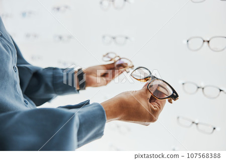 Glasses choice, black woman hands and customer with store worker at optician looking at lens. Eye consulting, smile and eyewear shopping in a frame shop for vision and prescription exam for eyes 107568388