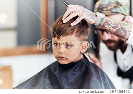 Youre never too you to start looking your best. Cropped shot an adorable little boy getting a haircut at the barbershop. Youre never too you to start looking your best. Cropped shot an adorable little boy getting a haircut at the barbershop. 107568492