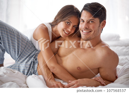 Love, bedroom portrait and happy couple hug during morning peace, calm or bonding quality time together. Smile, vacation and romantic people relax in hotel bed for Valentines Day holiday in Argentina 107568537