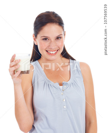 Happy woman, portrait and glass of dairy milk for vitamin D healthcare benefits, bone health or nutritionist hydration drink. Calcium product, wellness and studio model isolated on white background Happy woman, portrait and glass of dairy milk for vitamin D healthcare benefits, bone health or nutritionist hydration drink. Calcium product, wellness and studio model isolated on white background 107569539