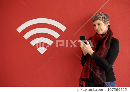Senior woman, phone and texting by wall with overlay, icon and wireless network with smile by red background. Mature lady, smartphone and reading on social media, chat and blog with connection sign Senior woman, phone and texting by wall with overlay, icon and wireless network with smile by red background. Mature lady, smartphone and reading on social media, chat and blog with connection sign 107569825