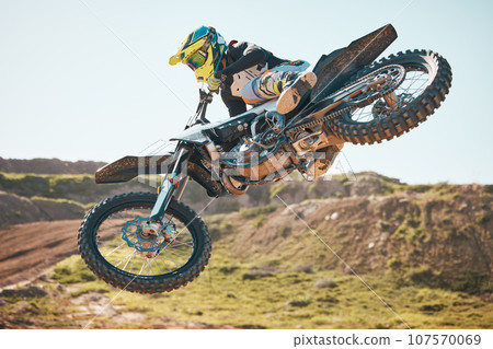 Motorcross, air jump and offroad sports stunt, speed challenge and desert rally. Driver, cycling and freedom on dirt race, competition and motorbike performance on adventure course for fast action 107570069