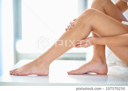 Skincare, soft and legs of a woman after waxing, grooming and cleaning in a bathroom. Beauty, moisturize and a person touching a leg after shaving or removing body hair for a treatment at home Skincare, soft and legs of a woman after waxing, grooming and cleaning in a bathroom. Beauty, moisturize and a person touching a leg after shaving or removing body hair for a treatment at home 107570250