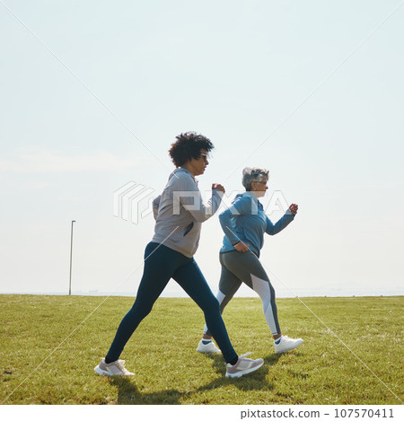 Women speed walking, fitness and cardio outdoor with training and energy with mockup space. Female people, team in park with exercise and race with sports and athlete, health and wellness in nature 107570411