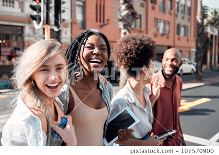 A Group of diverse students having fun outdoors in the city on a sunny summer day. Portrait of young people or friends laughing and smiling together in an urban town while walking to campus 107570900