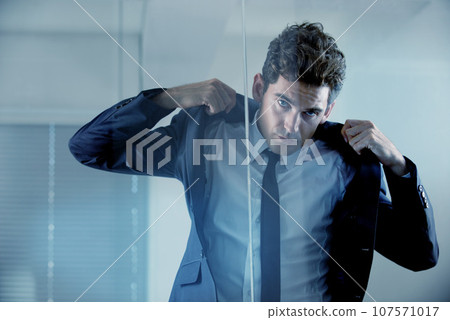 Morning, getting ready and portrait of a man in a suit for business, work and corporate job. Serious, looking and a businessman with style wearing a classy outfit for a professional executive career 107571017