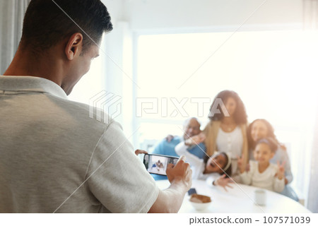 Smartphone photography, screen with family in home, man taking picture and memory with love and care. Technology, group and people together with focus, lens and photographer, app and phone 107571039