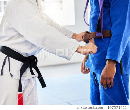 Belt, student and coach at karate training ready while learning, fitness and motivation in a class. Cardio, health and taekwondo teacher helping a man prepare for martial arts fight at a club 107571421