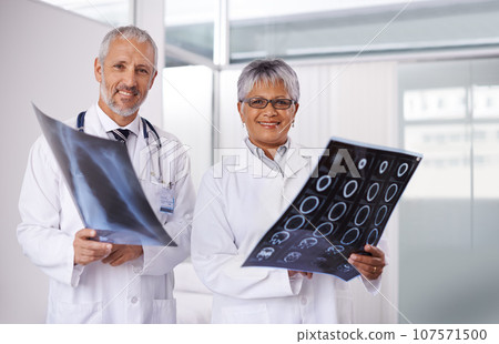 Senior team of doctors in portrait with xray, people in radiology with healthcare and medical collaboration. Anatomy scan for surgery, old man and woman surgeon with smile, happy working together 107571500