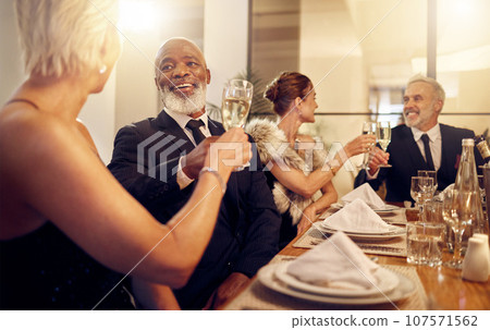 Man, toast and friends at restaurant party in night for diversity, business executive team and success. New year, celebration talk and people at gala with champagne, congratulations and solidarity Man, toast and friends at restaurant party in night for diversity, business executive team and success. New year, celebration talk and people at gala with champagne, congratulations and solidarity 107571562