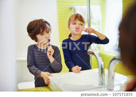 Children brushing teeth in home bathroom with toothbrush for hygiene and clean mouth. Oral healthcare or fresh breath, kids grooming while bonding and wellness with dental care at sink for dentist 107571855