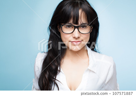 Smart is the new sexy. Shot of a beautiful young woman posing against a studio background. 107571887