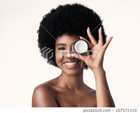 Portrait, black woman with cream and skincare, beauty and natural cosmetics product isolated on white background. Dermatology, afro hairstyle and African female model, lotion and facial moisturizer 107572310