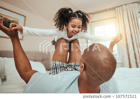 Dad, child and playing on bed flying for fun, quality time or bonding together in home, bedroom or girl in airplane game. Happy, father and daughter in air with knees and arms raised with freedom Dad, child and playing on bed flying for fun, quality time or bonding together in home, bedroom or girl in airplane game. Happy, father and daughter in air with knees and arms raised with freedom 107572521