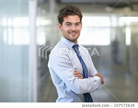 Hes a mover and shaker. Shot of a young businessman in a corporate office. 107572626