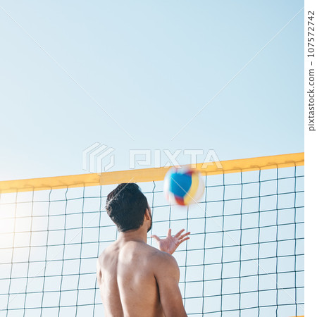 Sports, beach or man with volleyball on blue sky for exercise, fun competition or contest with mockup space. Back of male person throw to serve ball at sea for fitness, outdoor summer games or action Sports, beach or man with volleyball on blue sky for exercise, fun competition or contest with mockup space. Back of male person throw to serve ball at sea for fitness, outdoor summer games or action 107572742