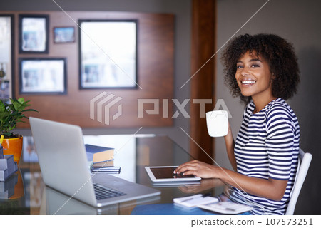 Laptop, tablet and portrait of woman with coffee for work from home opportunity, freelancer career and happy job. Face of young African person on multimedia or digital project and tea for inspiration Laptop, tablet and portrait of woman with coffee for work from home opportunity, freelancer career and happy job. Face of young African person on multimedia or digital project and tea for inspiration 107573251