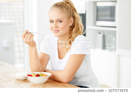 Fruits, morning and portrait of eating woman with healthy lunch or breakfast meal or diet in home kitchen for wellness. Nutrition, health and vegan person smile and happy for salad and self care Fruits, morning and portrait of eating woman with healthy lunch or breakfast meal or diet in home kitchen for wellness. Nutrition, health and vegan person smile and happy for salad and self care 107573970