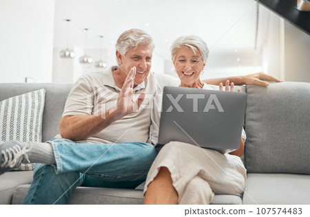 Laptop, wave or senior couple on video call in house or home for conversation or communication. Happy, hello or mature people speaking or talking on online web network on technology or social media 107574483