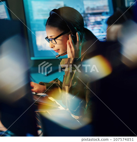 Military command center, headset and woman with communication, computer and technology. Security, global surveillance and soldier with teamwork in army office at government cyber data control room. Military command center, headset and woman with communication, computer and technology. Security, global surveillance and soldier with teamwork in army office at government cyber data control room. 107574851