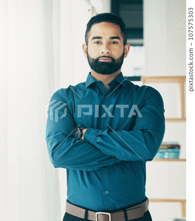 Portrait, serious and business man with arms crossed in office, startup company and workplace for creative career. Face, professional entrepreneur and confident designer, employee or worker in Brazil 107575303