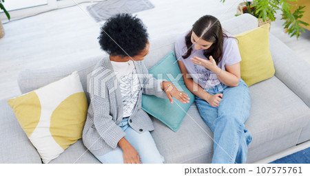 Engagement, ring and woman show friends, jewelry and girls excited for wedding, commitment or marriage . Hand, diamond and above happy women on sofa with surprise, announcement and news of fiance 107575761