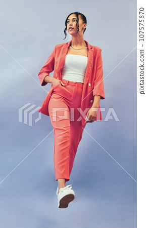 Business woman, thinking and corporate fashion with gen z style and trendy clothes for work. Studio, blue background and intern with worker confidence and career pride with stylish suit for job 107575870