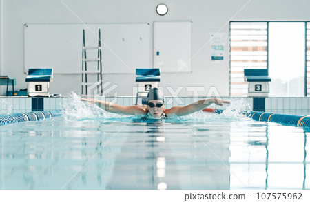 Pool, water splash and sports person swimming, training and practice challenge, fitness or workout routine in gym. Swimmer stroke, commitment and athlete cardio, race competition or match action Pool, water splash and sports person swimming, training and practice challenge, fitness or workout routine in gym. Swimmer stroke, commitment and athlete cardio, race competition or match action 107575962