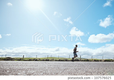 Marathon runner, fitness and man on road outdoor, cardio or healthy body. Athlete training, sport and exercise in competition, workout energy or race on street in wellness at countryside mockup space Marathon runner, fitness and man on road outdoor, cardio or healthy body. Athlete training, sport and exercise in competition, workout energy or race on street in wellness at countryside mockup space 107576025