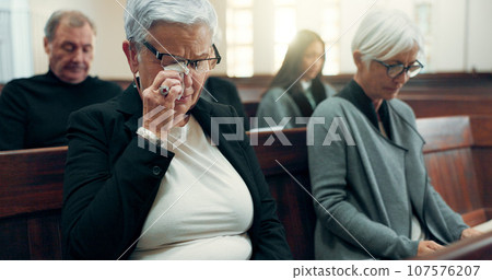 Sad, funeral or old woman crying in church for God, holy spirit or religion in cathedral or Christian community. Tissue, depressed or upset elderly person in chapel or sanctuary for Jesus Christ Sad, funeral or old woman crying in church for God, holy spirit or religion in cathedral or Christian community. Tissue, depressed or upset elderly person in chapel or sanctuary for Jesus Christ 107576207