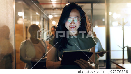 Night, tablet and business people walking in office after finishing work task. Tech, overtime and Asian woman with group of friends going home after working late on sales project in dark workplace. 107576258