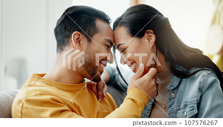 Couple, forehead touch and relax on sofa with love, bonding and happy people together at home. Healthy relationship, trust and support in commitment, partner and marriage, romance and intimacy 107576267
