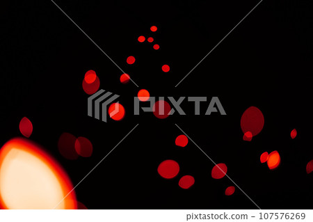 Red, glitter and bokeh in a studio with dark background for celebration, event or party. Confetti, lights and color sparkles for magic, shine or glow for festive by black backdrop with mockup. Red, glitter and bokeh in a studio with dark background for celebration, event or party. Confetti, lights and color sparkles for magic, shine or glow for festive by black backdrop with mockup. 107576269