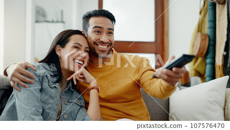 Happy couple, relax and watch movies on tv, news and cable show for media broadcast on sofa at home. Man, woman and people change television remote for streaming multimedia, subscription and choice Happy couple, relax and watch movies on tv, news and cable show for media broadcast on sofa at home. Man, woman and people change television remote for streaming multimedia, subscription and choice 107576470