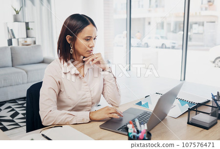 Web designer, laptop and serious business woman reading project proposal online in a office. Report, female professional and thinking on a computer with typing and tech research for website analysis 107576471