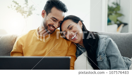 Happy couple, laptop and relax in home for love, watch comedy movies or scroll website for online shopping. Man, woman and laugh for funny joke on computer, social media subscription and meme on sofa 107576483
