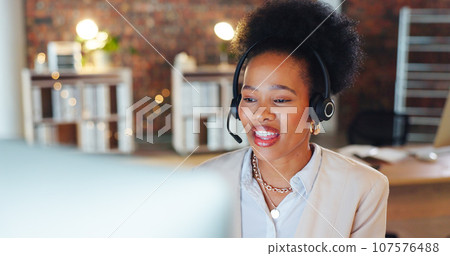 Woman, call center and computer in night, talk and office for telemarketing, voip mic and contact us. African consultant, crm and tech support agent for customer care, ideas or questions at help desk Woman, call center and computer in night, talk and office for telemarketing, voip mic and contact us. African consultant, crm and tech support agent for customer care, ideas or questions at help desk 107576488