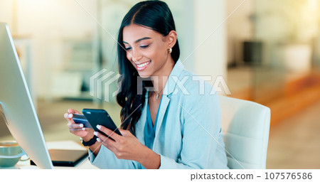 Happy woman making online payment with phone and bank card for typing credit details into online banking app. Young business woman enjoying virtual shopping or wireless purchase while sitting inside Happy woman making online payment with phone and bank card for typing credit details into online banking app. Young business woman enjoying virtual shopping or wireless purchase while sitting inside 107576586