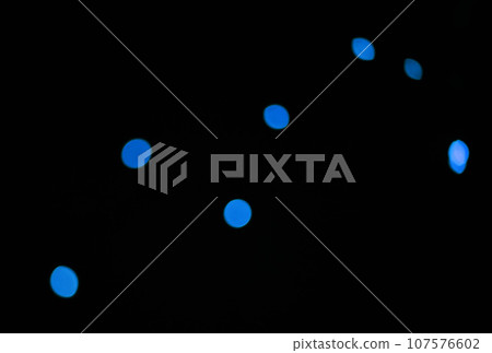 Bokeh, blue dots and lights on black background with pattern, texture and mockup with cosmic aesthetic. Night lighting, sparkle particles and glow on dark wallpaper with space, color shine and flare. Bokeh, blue dots and lights on black background with pattern, texture and mockup with cosmic aesthetic. Night lighting, sparkle particles and glow on dark wallpaper with space, color shine and flare. 107576602