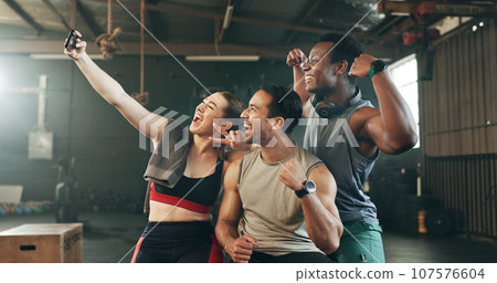 Selfie, teamwork and fitness with friends at gym for social media, workout and health. Support, profile picture and wellness with people and training for smile, photography and exercise together Selfie, teamwork and fitness with friends at gym for social media, workout and health. Support, profile picture and wellness with people and training for smile, photography and exercise together 107576604
