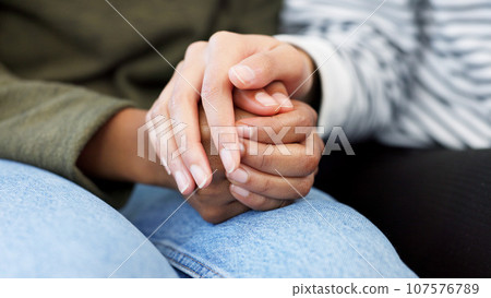 Holding hands, support and closeup of a couple in therapy for love, respect or trust in marriage. Together, hope and people with care, help and in counseling for relationship with compassion Holding hands, support and closeup of a couple in therapy for love, respect or trust in marriage. Together, hope and people with care, help and in counseling for relationship with compassion 107576789