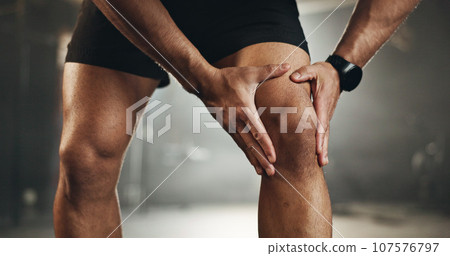 Fitness, knee pain and hands of man at gym for training with muscle, problem or arthritis. Sports, injury and leg of male athlete with joint massage for fibromyalgia, osteoporosis or bone accident 107576797