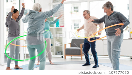 Fitness, senior and people with hula hoop at the gym for training, workout and health in retirement. Happy, together and a group of elderly friends with a coach and gear for an exercise class 107577050