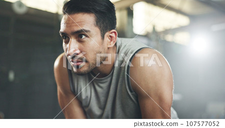 Sweat, fitness and man tired from gym, workout or rest in training in cardio, sports and body builder breathing with fatigue. Exhausted, break and athlete with commitment for health challenge 107577052