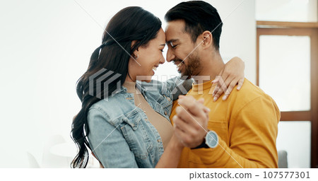 Couple, forehead touch and hug in living room with love, bonding and happy people together at home. Healthy relationship, trust and support in commitment, partner and dancing, romance and intimacy Couple, forehead touch and hug in living room with love, bonding and happy people together at home. Healthy relationship, trust and support in commitment, partner and dancing, romance and intimacy 107577301