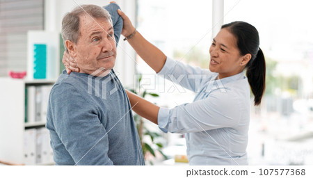 Old man, patient and physiotherapy of arm, medical rehabilitation or consulting doctor. Woman, physiotherapist and stretching for assessment of shoulder pain, arthritis or healthcare advice in clinic 107577368