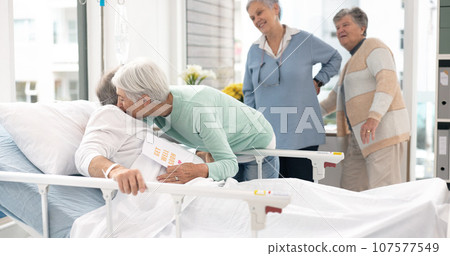 Hospital, sick and friends visit man for comfort, care and support for wellness, service and surgery. Healthcare, medical clinic and women with patient for recovery, rehabilitation and happiness 107577549